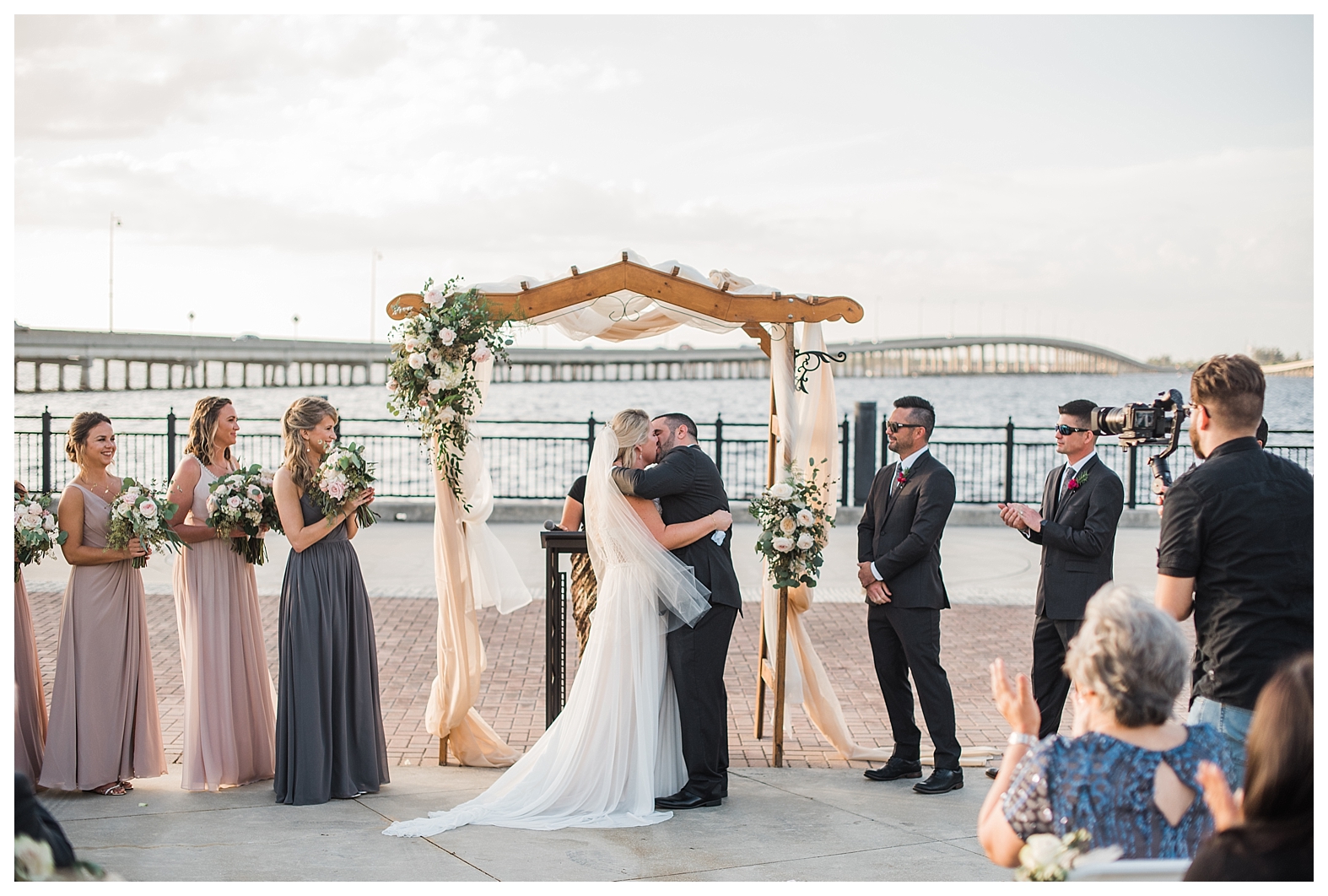 colorful bridesmaid dress, nude palette bridesmaid dress, first kiss, first kiss inspiration photo, ceremony overlooking the water, ceremony by water, florida ceremony, punta gorda ceremony, bay side ceremony