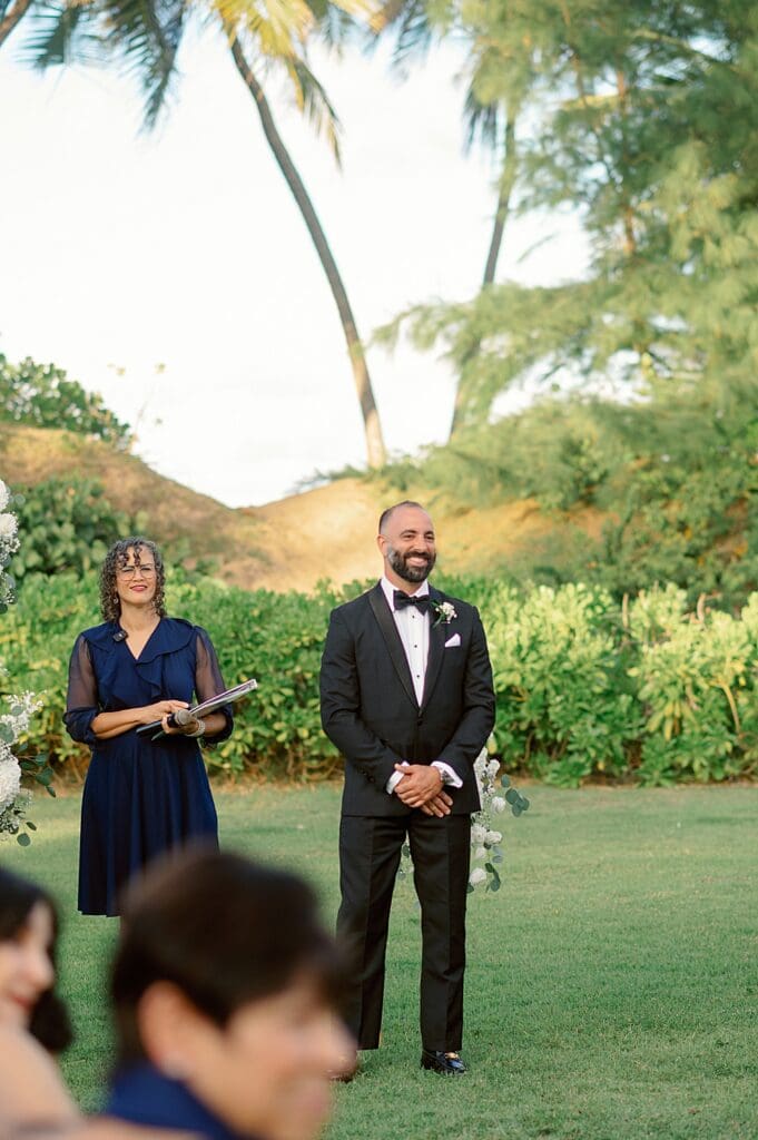 groom standing at the front of the aisle