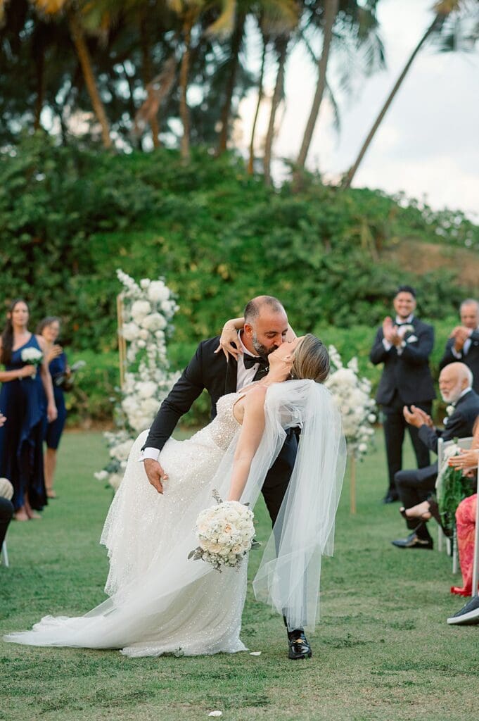 Bride and groom aisle kiss